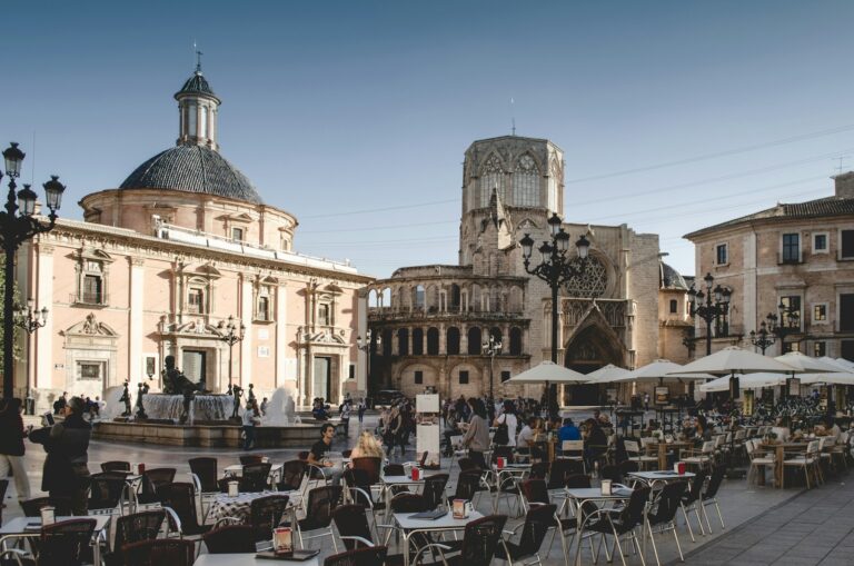 tables and chairs near building during daytime in Valencia